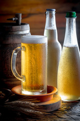 Light beer in a glass on a table in composition with accessories on an old background