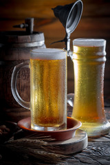 Light beer in a glass, on an old background.