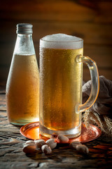 Light beer in a glass on a table in composition with accessories on an old background