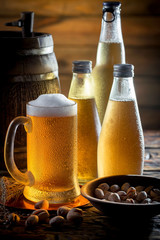 Light beer in a glass on a table in composition with accessories on an old background
