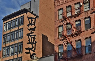 Bowery Street is a Busy Area in Lower East Side Manhattan New York City with Old Tenement Buildings