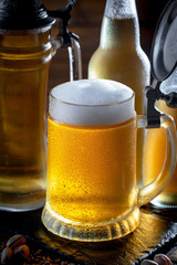 Light beer in a glass, on an old background.