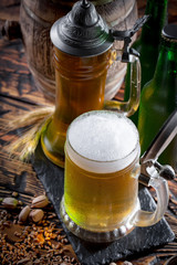 Light beer in a glass on a table in composition with accessories on an old background