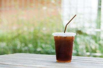 A glass of ice americano coffee in cafe