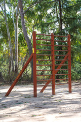 View of wooden apparatus for training in a sports area of a park with trees, in Madrid, Spain. Vertically