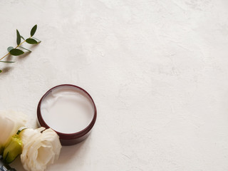 composition with cream flower and eucalyptus on white texture background. Concept beauty natural cosmetic product, skin care, copyspace, top view