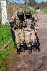 Soldier helped another to walk