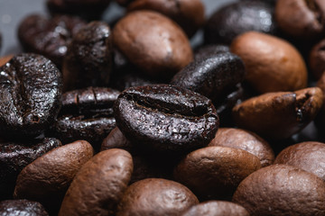 Macro view of natural and roasted coffee mix beans 