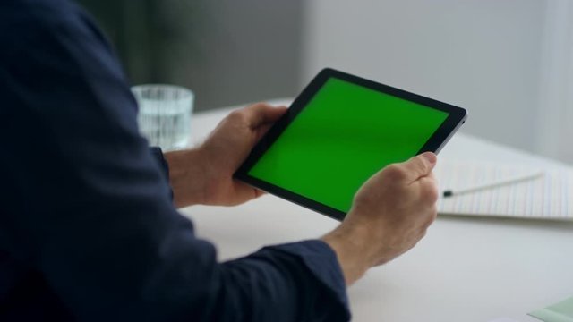 Man hands holding tablet with green screen. man reading letter on paddle cell.