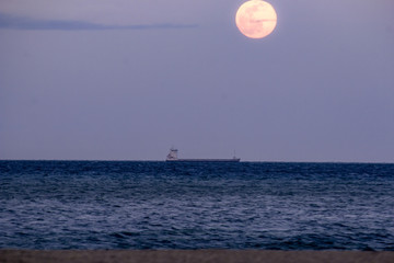 boat on the sea at full moon
