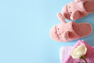 women's slippers and towels on a blue background