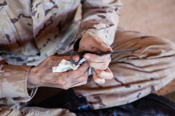 soldier cleaning a bayonet