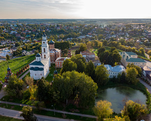 Aerial photo of the old Russian Kremlin in Volokolamsk, near the lake, in the background nature and country houses.