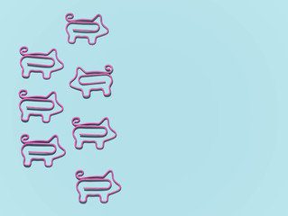 top view of group with pigs paper clips in one direction and one in different isolated on blue