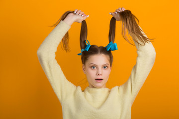 beautiful young woman with long hair on a yellow background