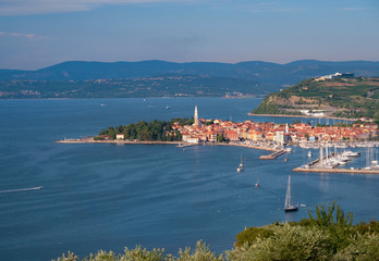 Fototapeta na wymiar AERIAL: Flying away from harbor of a historic old town in the Adriatic sea.