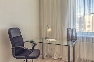 Clean modern home office with transparent glass desk