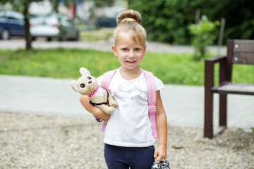Little girl holds a toy. Back to school. The concept of school, study, education, childhood