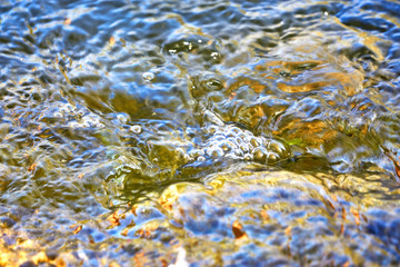 Close up of small ruffles wave from the wind on the water as nature background.