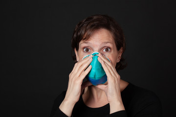 Scared Woman wearing a hospital grade N95 mask