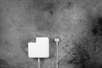 magSafe 2. Apple Power Adapter laptop charger. MacBook keyboard a metal background	