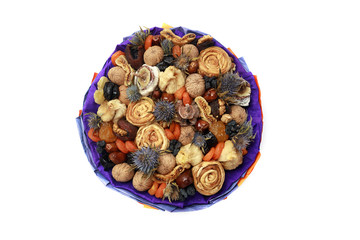Bouquet of dried fruits with blue spines wrapped in blue paper, top view