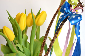 Spring composition: two easter whips with bunch of yellow tulips