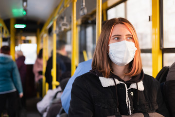 Young adult commutes in a protective face mask. Coronavirus, COVID-19 spread prevention concept,...