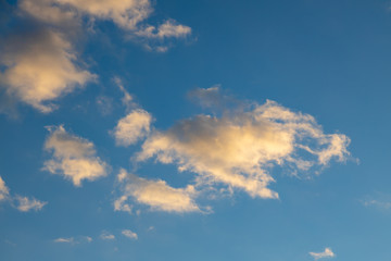 Sunset cloud on a moody vivd blue sky. Stormy and windy weather cumulus cloud at springtime.