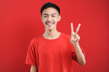 Young Asian man with number two sign finger gesture