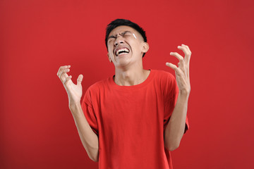 Fototapeta premium Young Asian man doing angry gesture, annoyed, and emotional