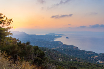 Crete island beach and mountains in sunset time. Greece vacation.