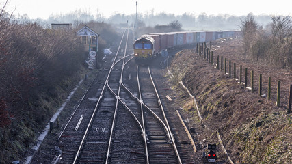 Freight train passing through the Suffolk countryside by Chippenham junction onwards to Felixstowe.