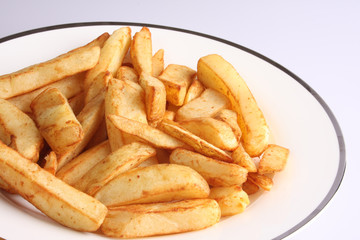 A studio photograph of cooked oven chips