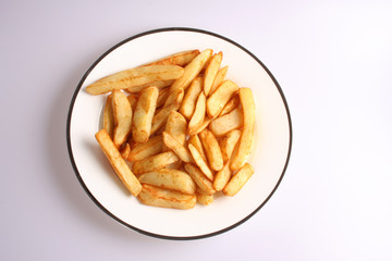 A studio photograph of cooked oven chips