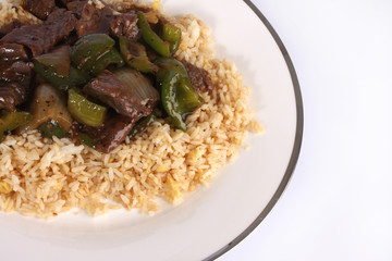 Chinese Cuisine, beef and black bean sauce with egg fried rice against a white background