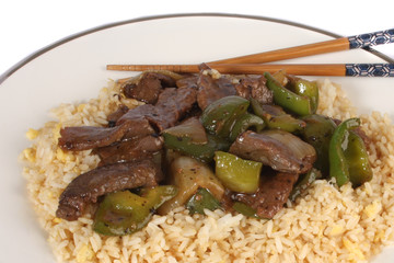 Chinese Cuisine, beef and black bean sauce with egg fried rice against a white background