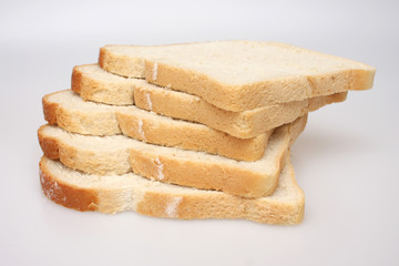 A studio photograph of 5 slices of white bread