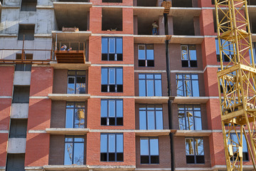 Obraz premium Construction site. High rise Building under construction. Construction of high-rise residential building