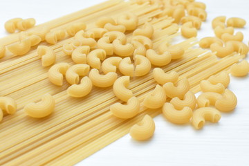 Italian long and short pasta, on white wooden background