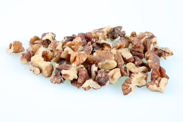 A studio photograph of a handful of walnuts