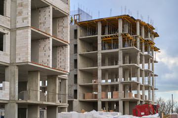 Obraz premium Construction site. High rise Building under construction. Construction of high-rise residential building