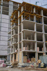 Obraz na płótnie Canvas Construction site. High rise Building under construction. Construction of high-rise residential building