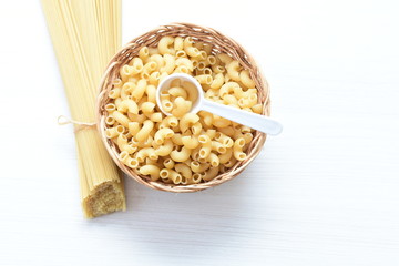 Italian long and short pasta, on white wooden background