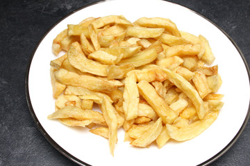 A plate of deep fried potato chips from an English Fish and Chips shop
