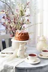 bundt cake.  Easter orthodox sweet bread with flowers.  Easter breakfast table setting. Decoration for Easter family celebration.