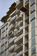 Obraz premium Construction site. High rise Building under construction. Construction of high-rise residential building