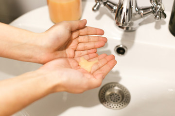 Washing hands. Taking soap on hands palm in bathroom, hands washing to prevent coronavirus epidemic. Prevention of flu disease. Washing hands in proper technique