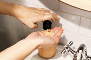 Washing hands. Taking soap on hands palm in bathroom, hands washing to prevent coronavirus epidemic. Prevention of flu disease. Washing hands in proper technique