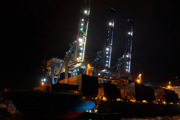 Fototapeta na wymiar Containers loading by crane in the night , Trade Port. container operation in port series